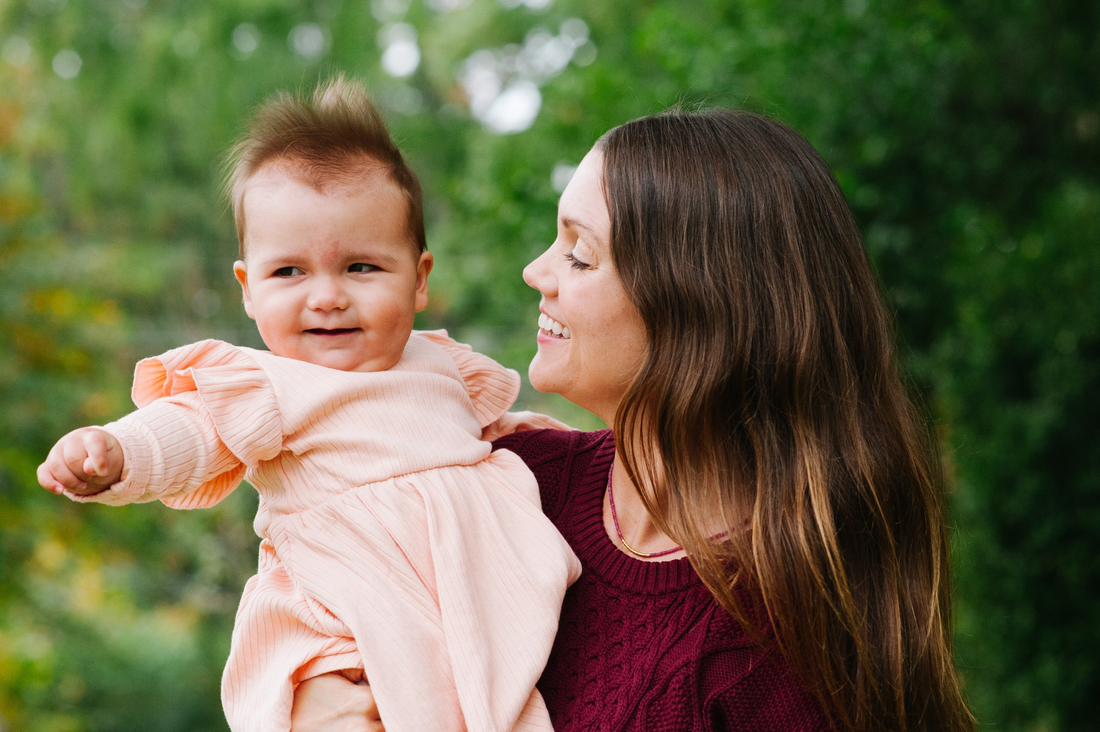 ADHD mother holding neurodivergent baby