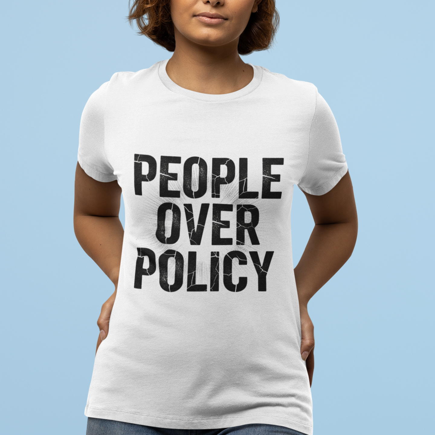 Person wearing a white t-shirt with 'People Over Policy' text on a light blue background