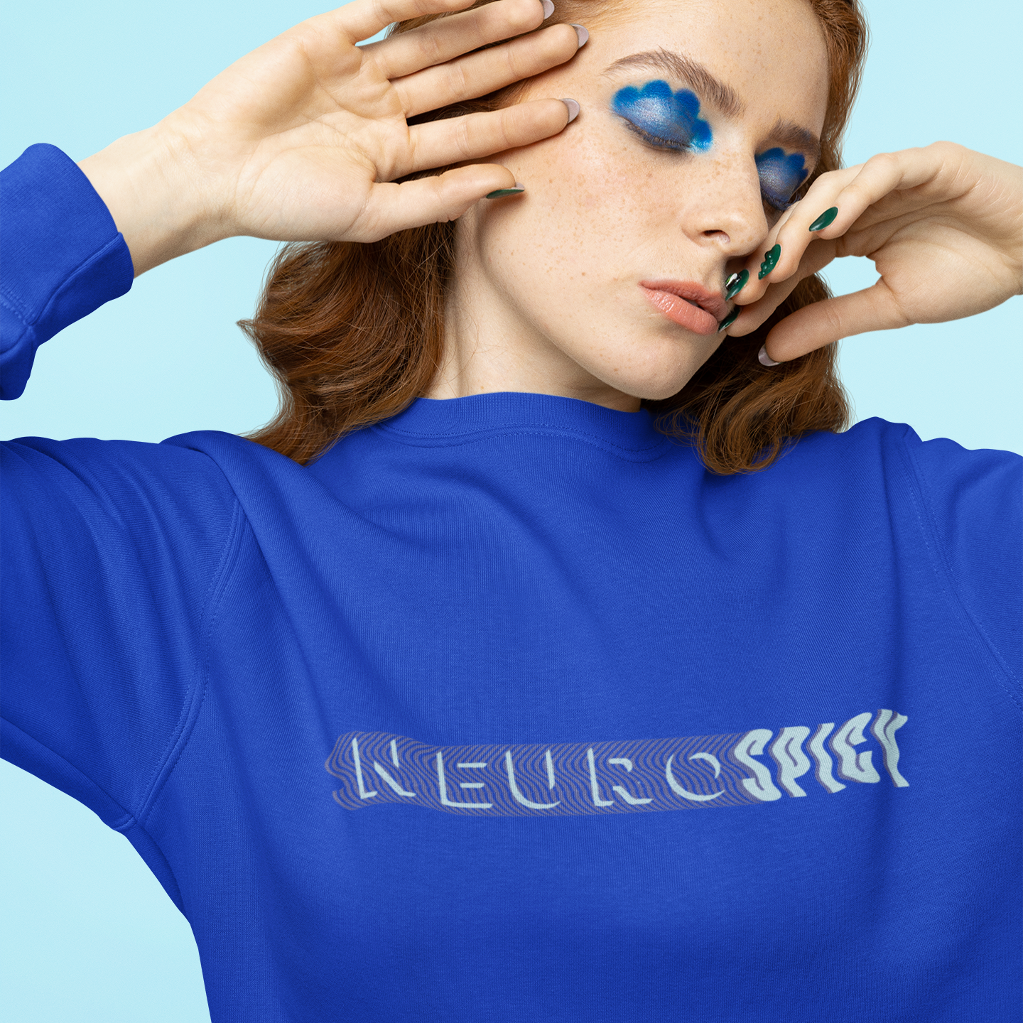 Person wearing a blue sweatshirt with 'NEUROspicy text against a light blue background