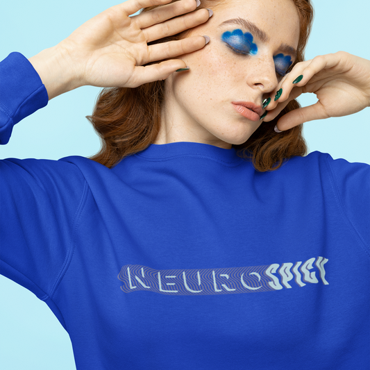 Person wearing a blue sweatshirt with 'NEUROspicy text against a light blue background