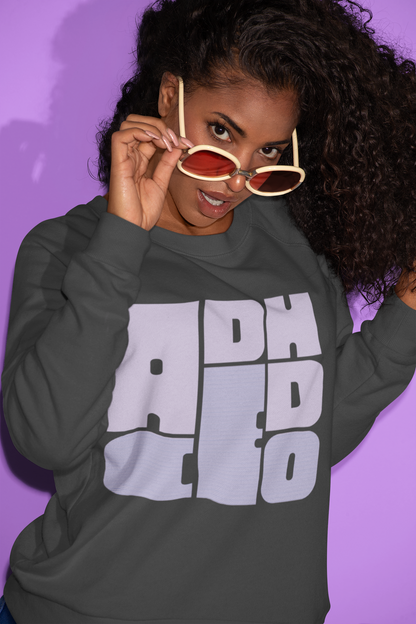 Person wearing a dark gray sweatshirt with 'ADHD CEO' text, holding sunglasses, against a purple background.