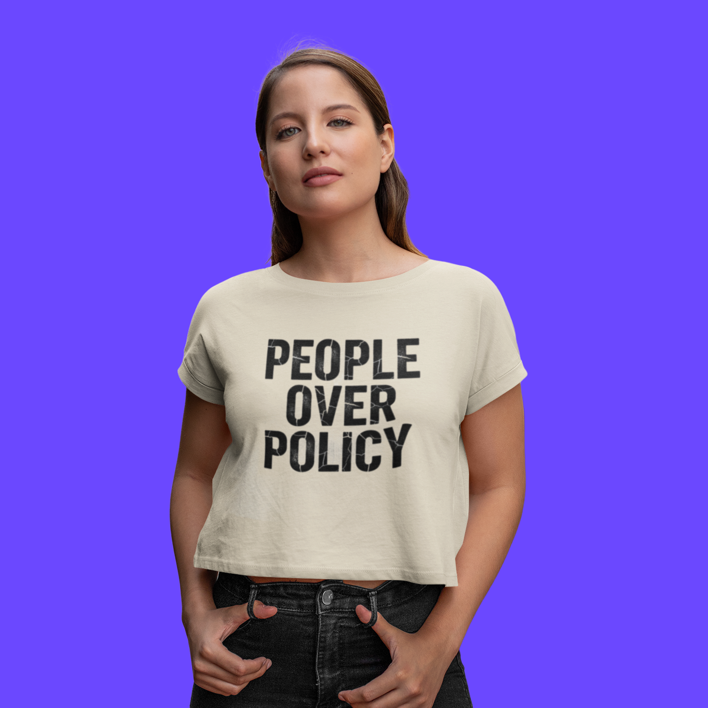 Person wearing a t-shirt with 'People Over Policy' text on a purple background